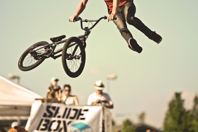 Mountain biker performing jump - adventure sports activity available for booking